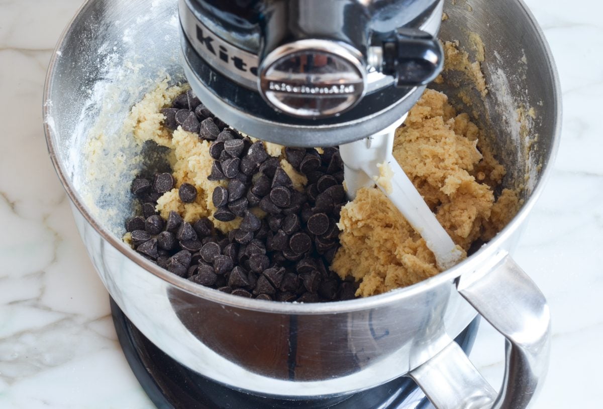 adding chocolate chips to the dough