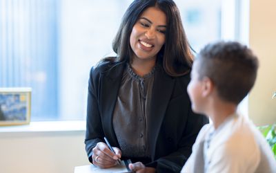 Therapist Warmly encouraging a Young Boy